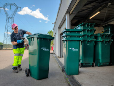 Un agent du service déchets rangeant des bac à déchets dans l'une des déchetteries du territoire.