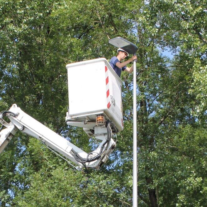 Un de nos agents de terrain sur une nacelle pour changer l'ampoule de la lanterne d'éclairage public.
